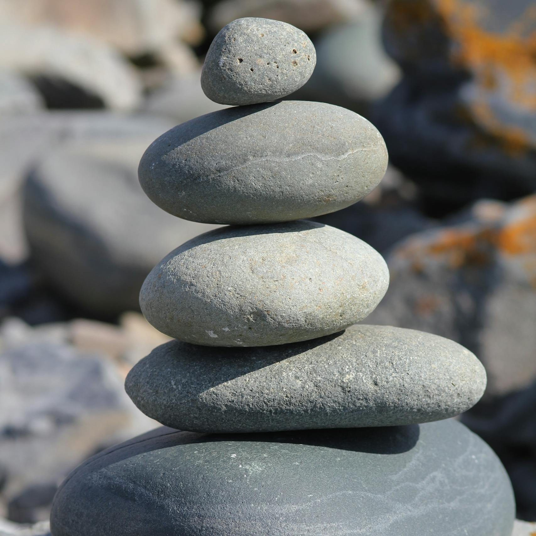 Stacked stones create a harmonious balance, exemplifying simplicity and tranquility in nature.